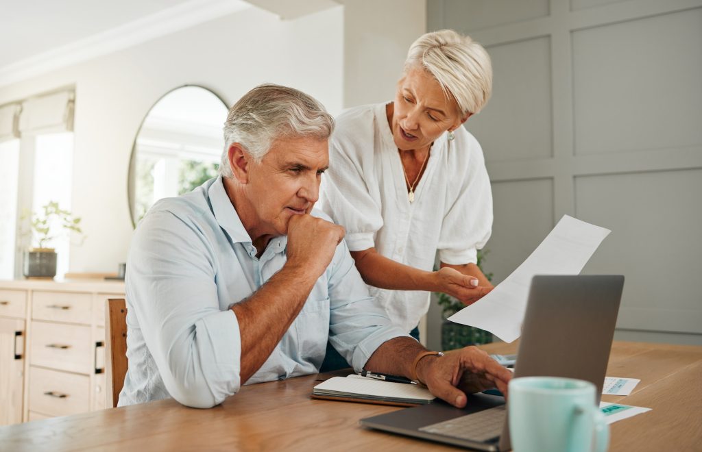 Retirement planning, finance communication and couple talking about insurance with laptop in living